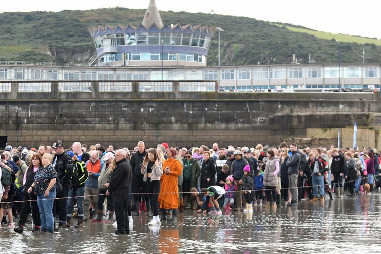 Thousands of people take part in a guided walk to the Tower of Refuge -