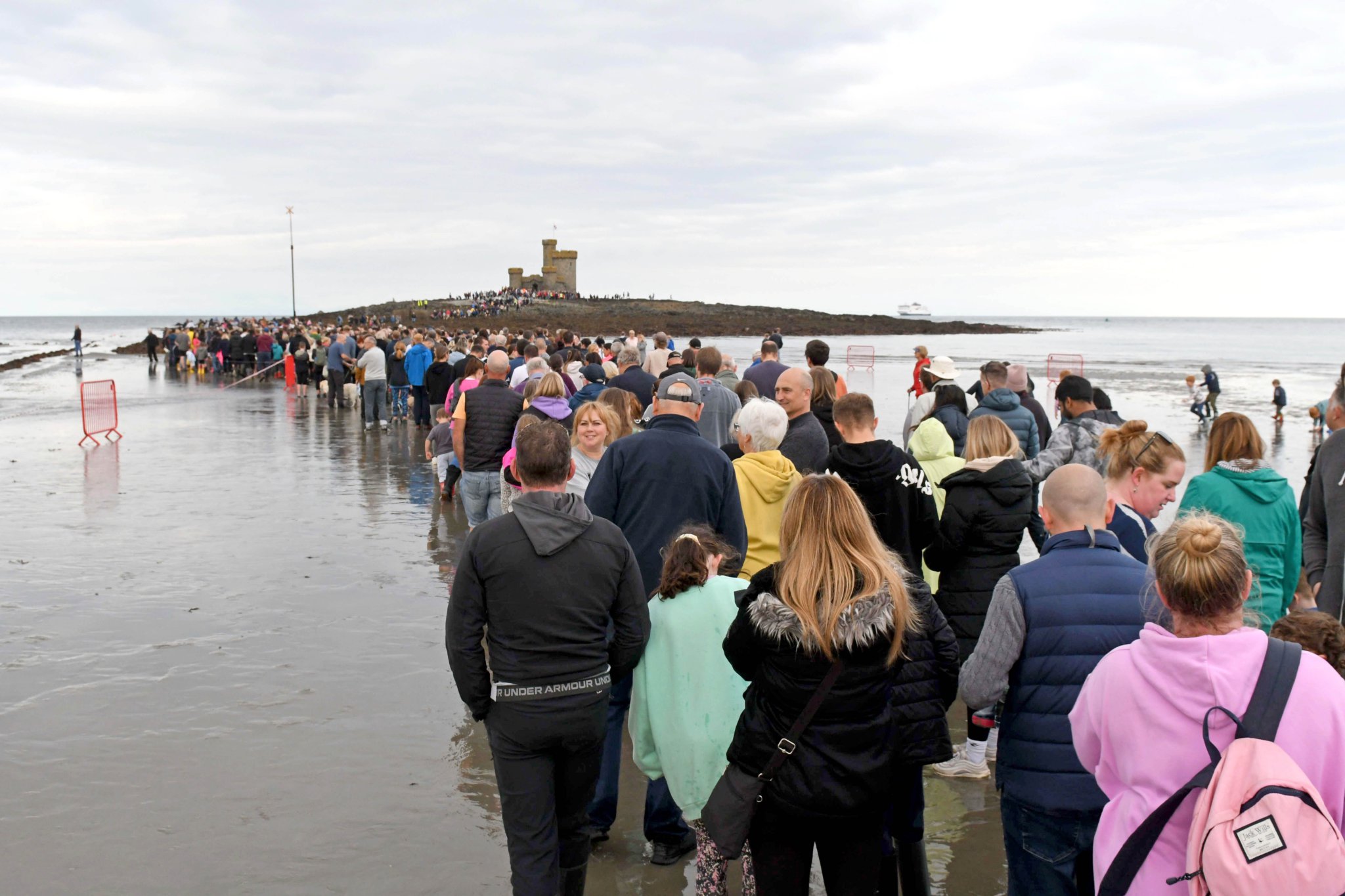 Thousands of people take part in a guided walk to the Tower of Refuge -