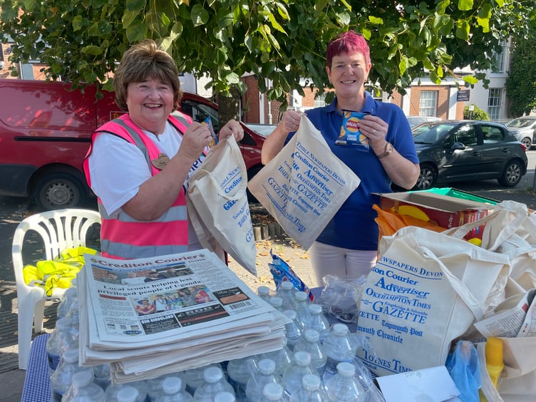 Stuffing goody bags on the Crediton Courier stall at the Festival. AQ 6461