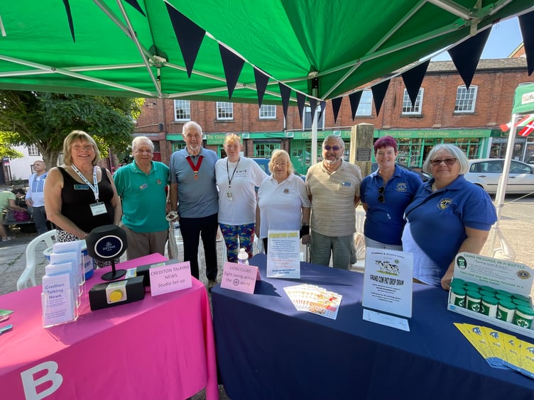 The RNIB, Crediton Talking News and Crediton Lions stalls volunteers. AQ 6478