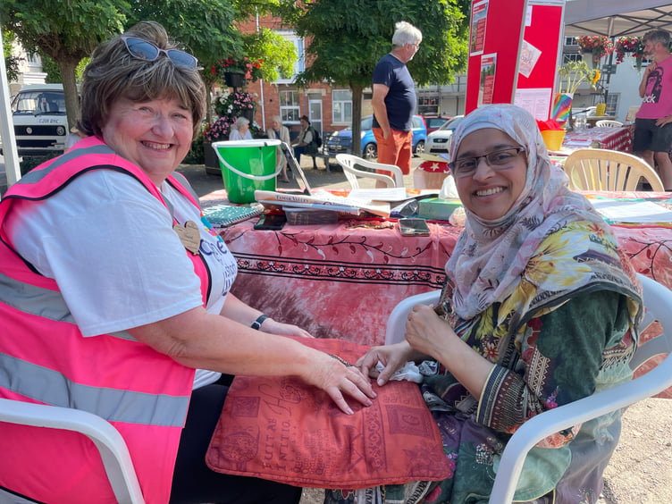 Neomi Alam, right, of Inclusive Exeter, offered Henna tattoos and is pictured with Hazel Evely, left, AQ 6534