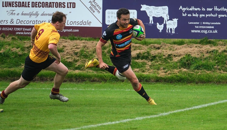 Douglas’s Kyle Martin attempts to prevent a Kirkby player from going over for a try (Photo: Tim Hancock)