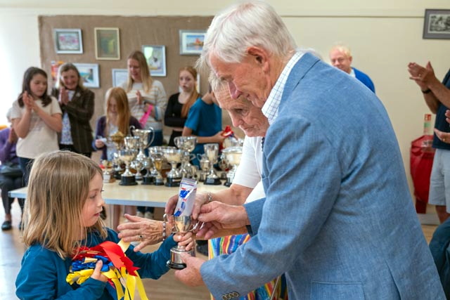 Poppy presented with her cup and rosettes for her handiwork at Walkhampton Flower Show.