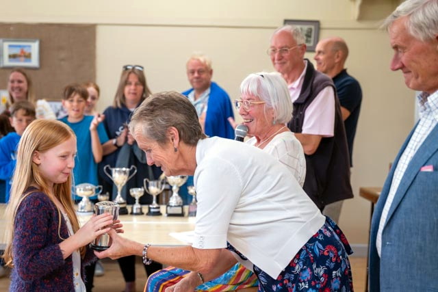 Lily proudly receives her trophy from the judges for her entries at Walkhampton Flower Show.