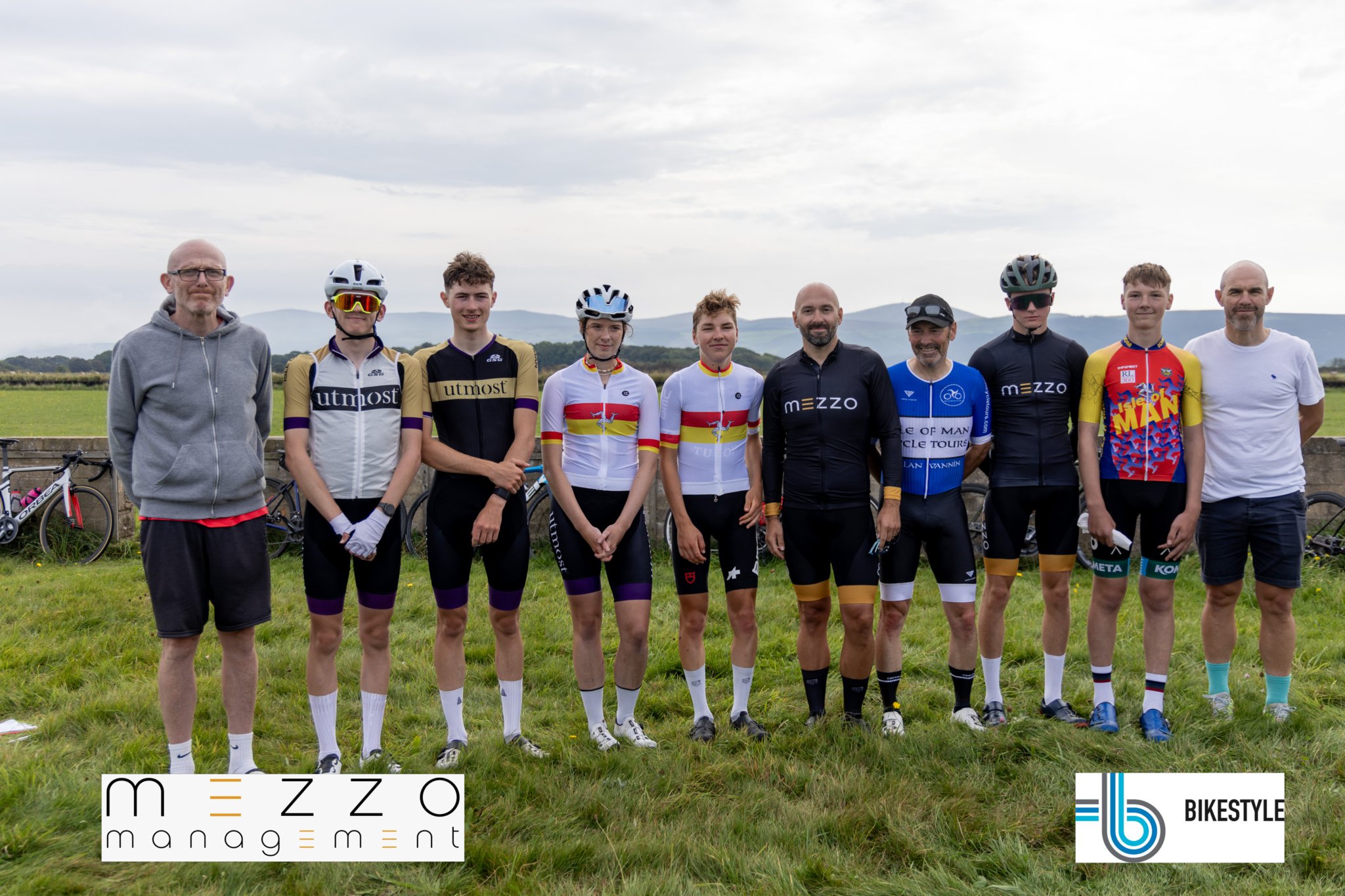 Line up of class winners at Sunday morning’s Isle of Man Closed Circuit Cycling Championships: (l-r) Gianni Epifani of the organising club Manx Viking Wheelers, Callum Salisbury, Niall Colquitt, Sophie Smith, Zac Walker, Tom Broadbent of sponsor Mezzo Management, Richard Fletcher, Cian Howard, Cameron Halsall and event organiser Rob Sorby (3 Legs Photography)