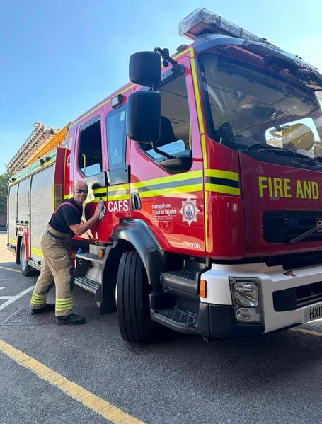 Fireman washing fire engine.