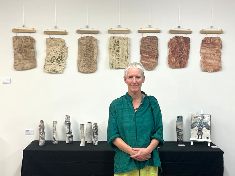 Lucy Rockliffe of Whitestone is pictured in front of her Bark Skin Series of paper clay fired hangings. The clay is pressed into the bark of the trees and clay prints made. She also makes large figure vessels using raku clays. AQ 6381