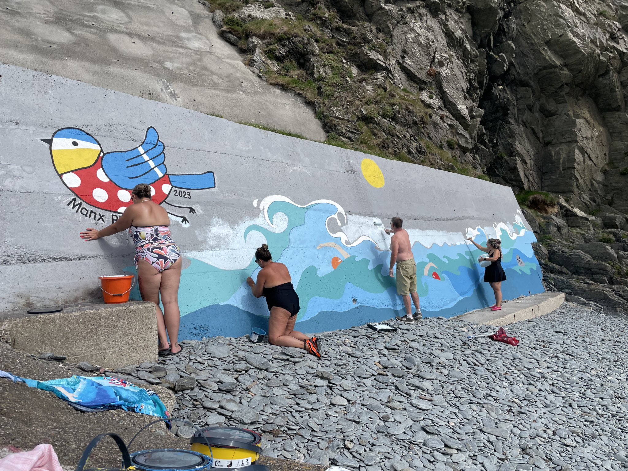 Members of the Manx Bluetits hard at work on their mural