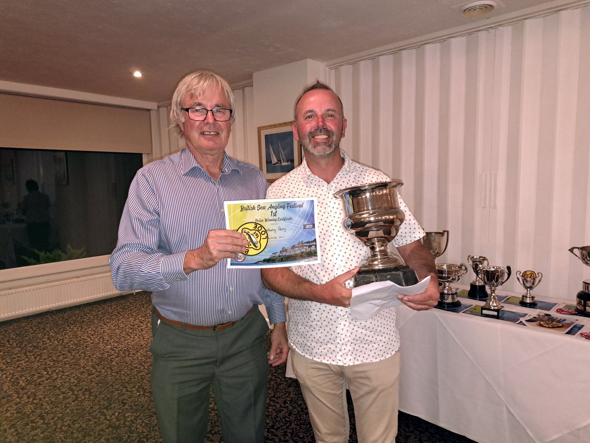 JOHN Shaw receives the Edgar Sealey Challenge Trophy for the angler with the most individual points from festival president Armand Toms