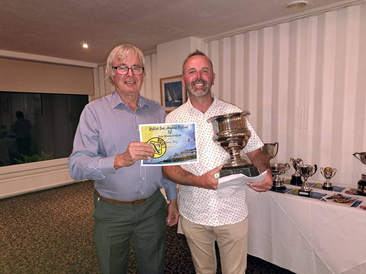 JOHN Shaw receives the Edgar Sealey Challenge Trophy for the angler with the most individual points from festival president Armand Toms