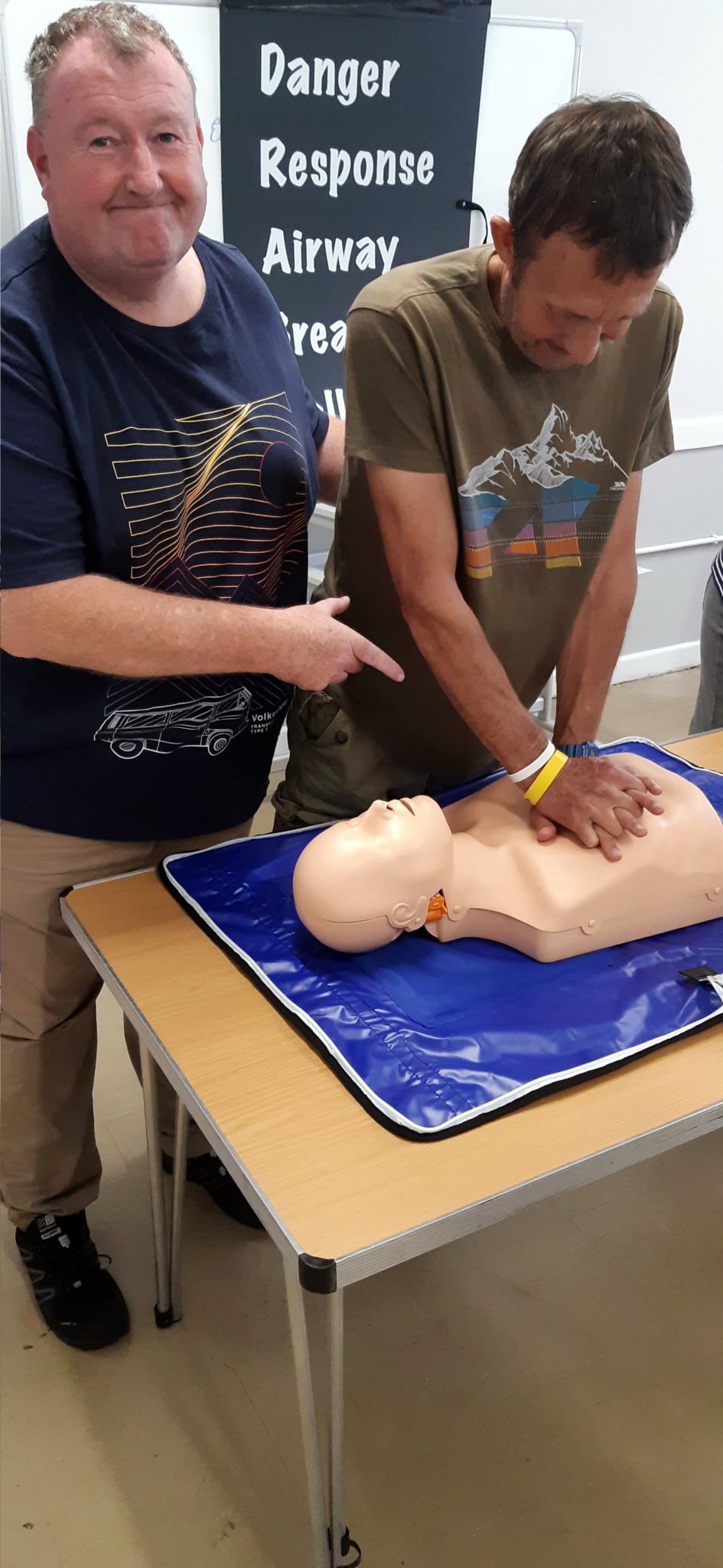 Paramedic Chris Pritchard takes trainee Rob Hodges through the basics of CPR.
