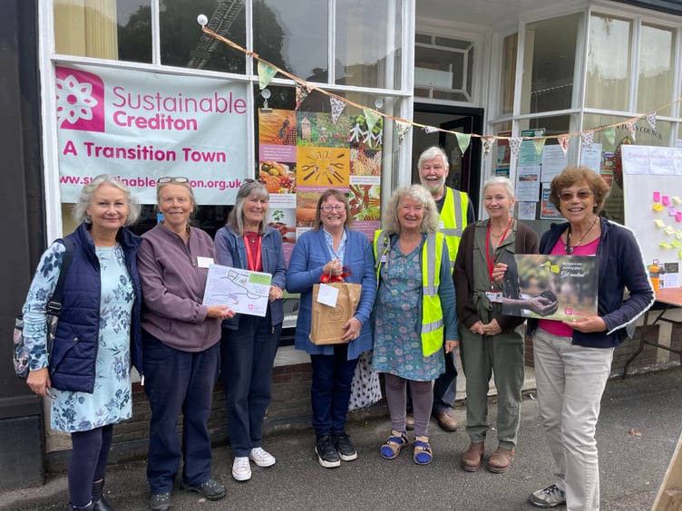 Dee Ross, fourth left, with her gift on her retirement as chair of Sustainable Crediton. AQ 7769