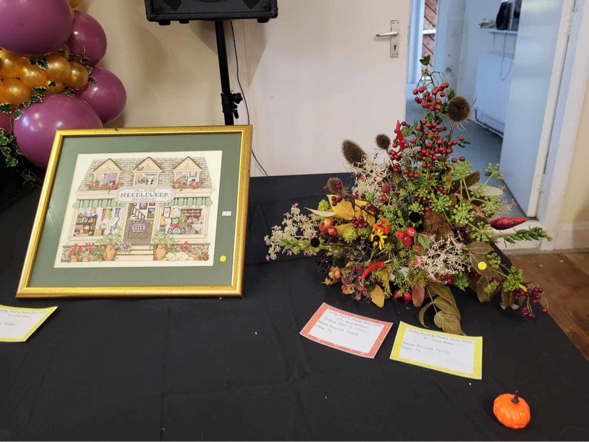 Sue Cooke won best in show for her framed cross-stitch exhibit