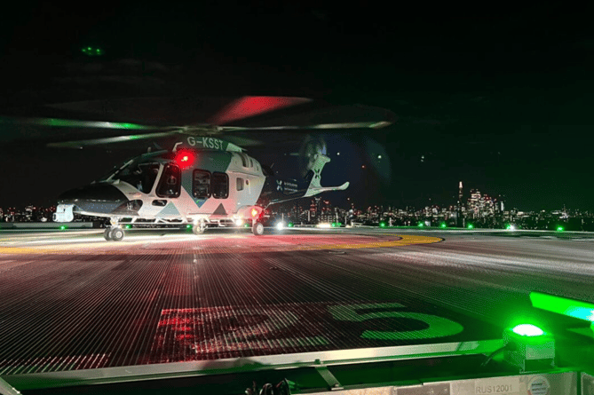 KSS helicopter on Kings College Hospital helipad at night