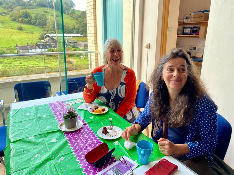 Lilly Russell and Jana Osborne enjoying a chat over a cuppa and a slice of cake at the Macmillan Coffee Morning at Calstock Arts.