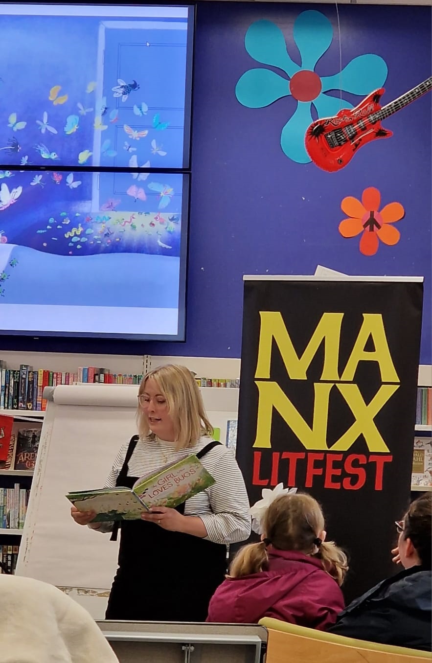Jenny Lovlie reads from a book she illustrated, The Girl Who Loves Bugs, at an event at the Family Library, Douglas