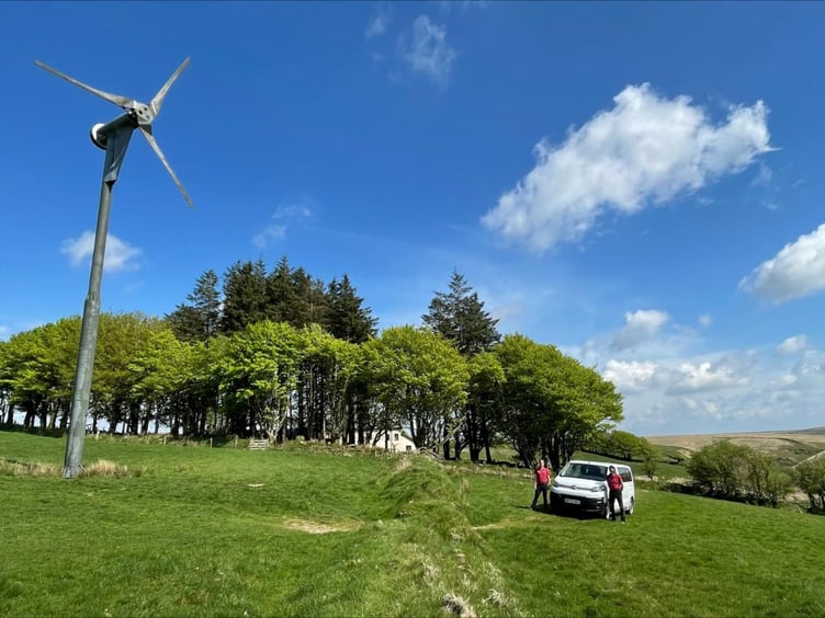 Pinkery's wind turbine and one of its electric vehicles.