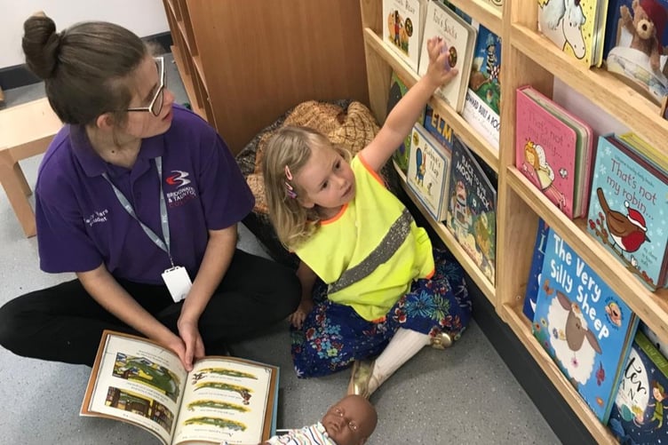 Reading is encouraged for nursery children attending a Bridgwater and Taunton College 'stay and play' session.