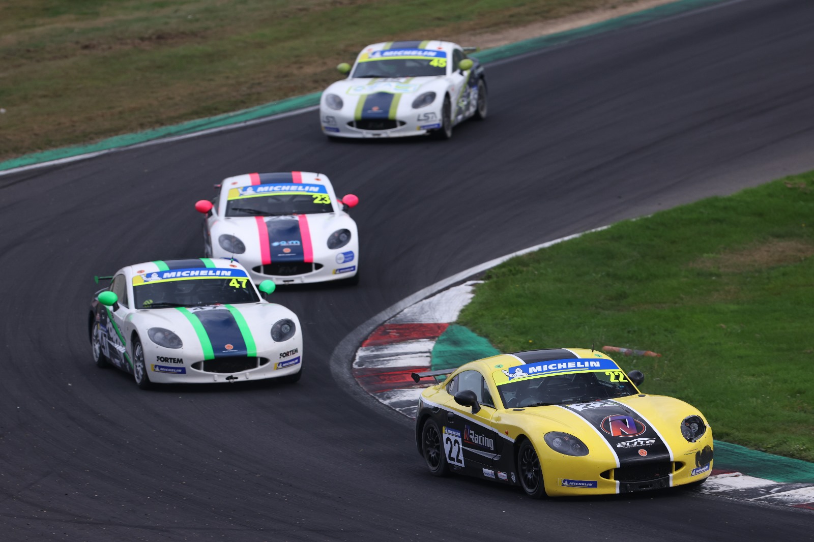 Nick Ellis leading a group of drivers  through Graham Hill Bend at Brands Hatch in his Ginetta Juniors debut last month. He is back in action the weekend after next at Donington Park  (Photo: Jakob Ebrey/ www.jakobebrey.com)