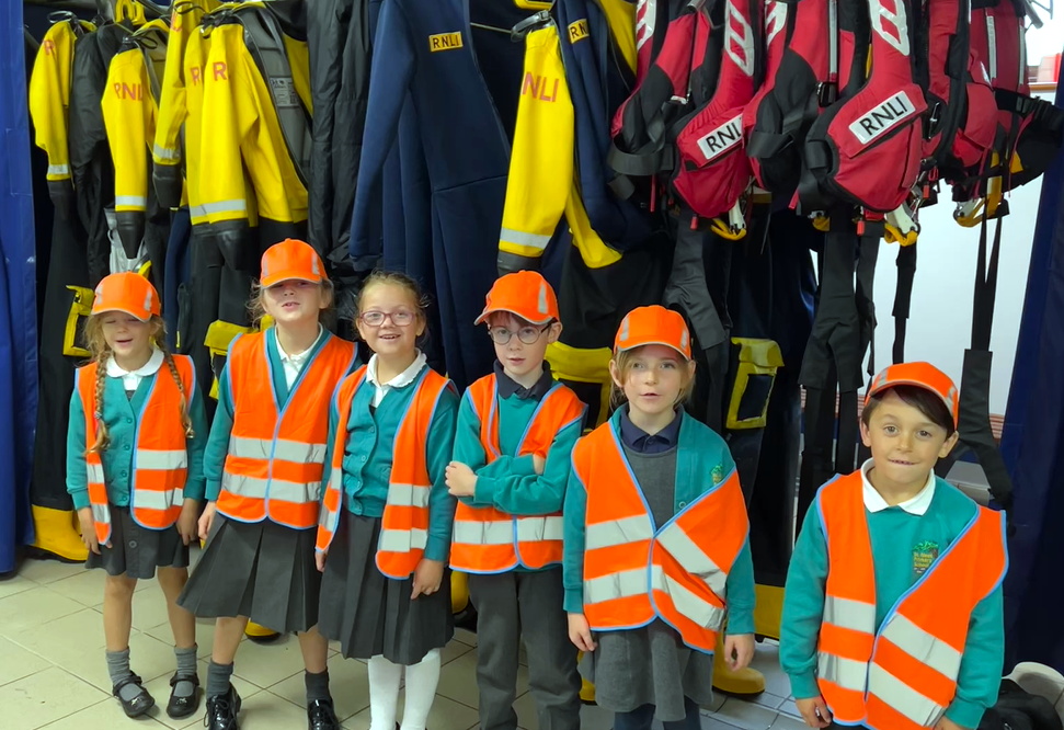 Students took a trip to Looe RNLI (above), Fistral Beach to learn all about surfing (right) and performed as part of this year’s Harvest Festival (top right)