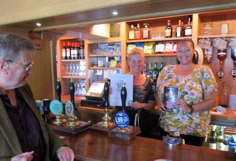 <p>With The Star Inn’s Good Beer Guide certificate and the guide are co-owner Sophie Croft and bar staff member Vanessa Payne. They are being congratulated by East Hants CAMRA pubs officer Tony Davis</p>