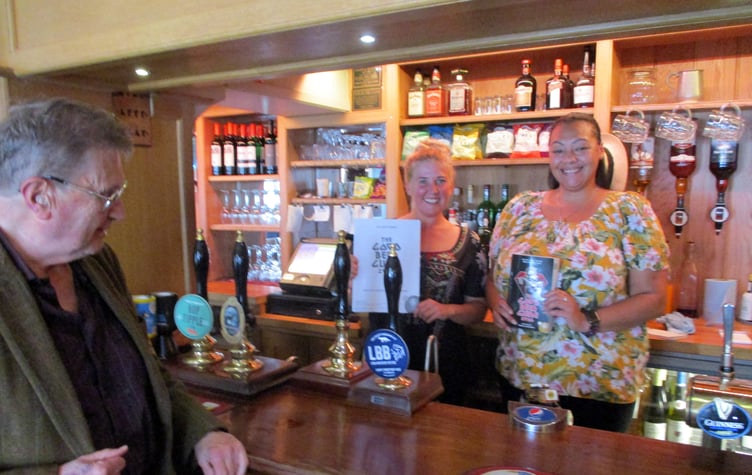 The Star Inn, Bentley, is in CAMRA's Good Beer Guide 2024, October 2023. With the certificate and guide, from left, are co-owner Sophie Croft and bar staff member Vanessa Payne. They are being congratulated by East Hants CAMRA pubs officer Tony Davis.