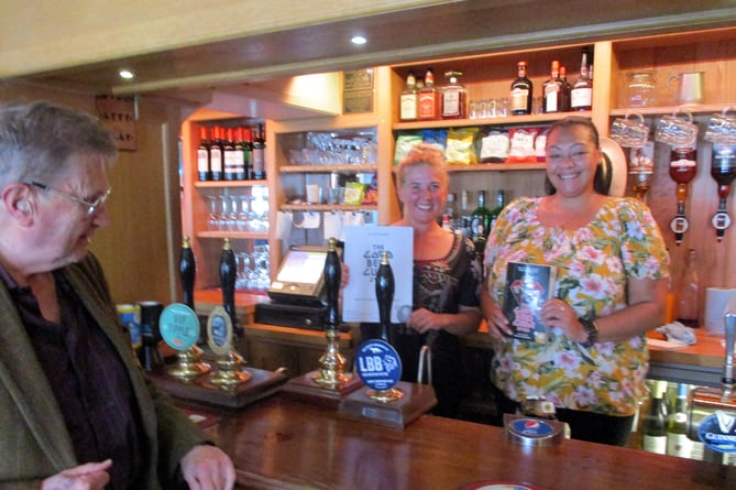 The Star Inn, Bentley, is in CAMRA's Good Beer Guide 2024, October 2023. With the certificate and guide, from left, are co-owner Sophie Croft and bar staff member Vanessa Payne. They are being congratulated by East Hants CAMRA pubs officer Tony Davis.