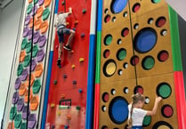 Ukrainian children go up the climbing wall at Alton Sports Centre