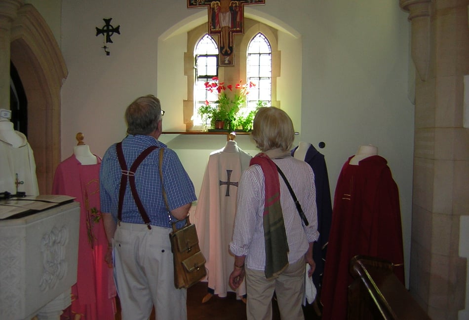 <p>Visitors inspect the priest’s vestments on show at Our Lady of Lourdes Church in Haslemere</p>
