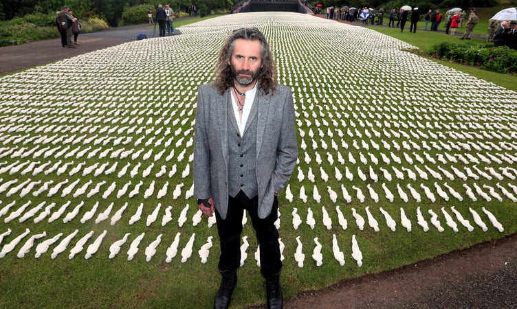 Rob Heard with the 19,240 'Somme' shrouds displayed in Northernhay Gardens, Exeter. The number later increased to 72,396.