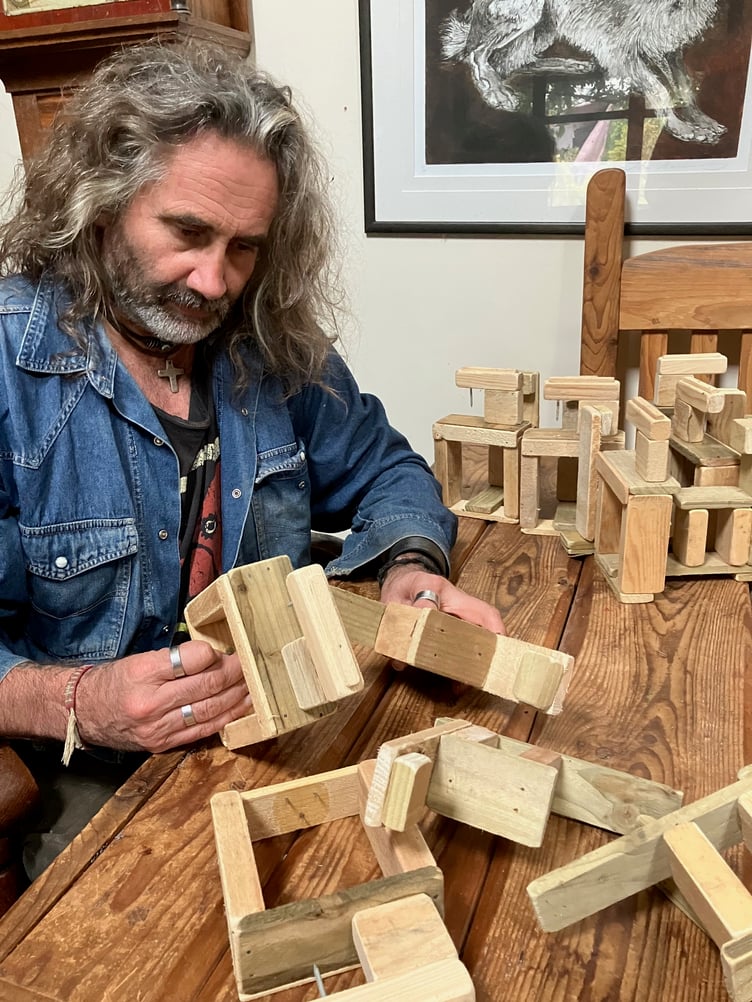 Rob works on the structures that support the figures.