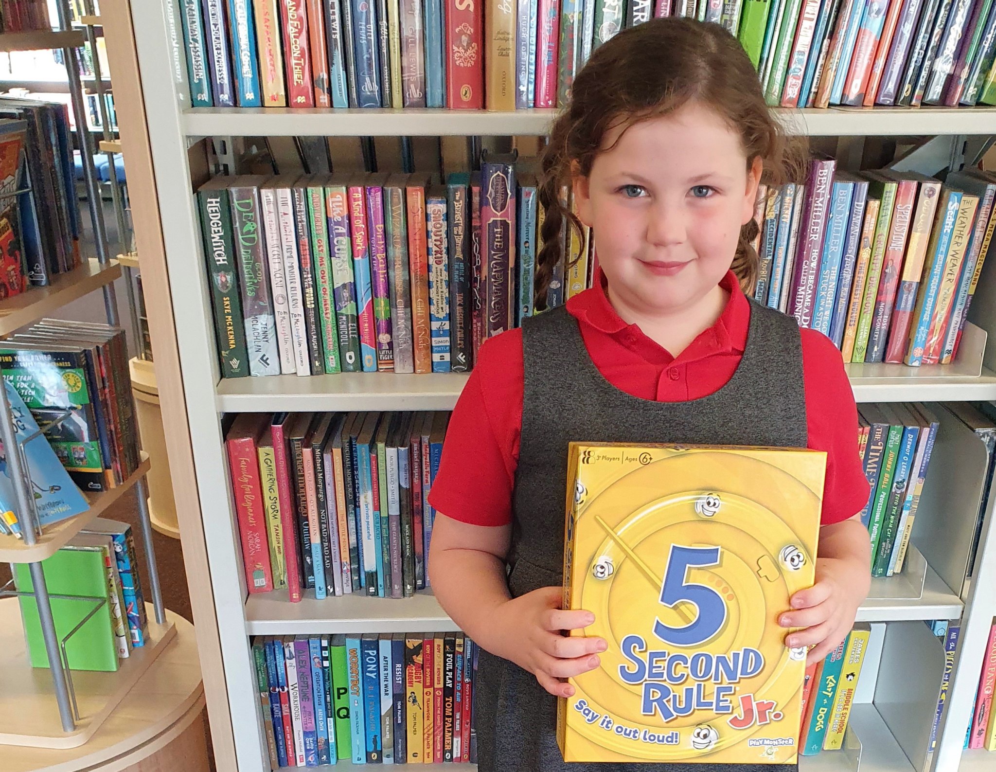 Katie with the game donated by Tesco that she won for reading six books during the summer.