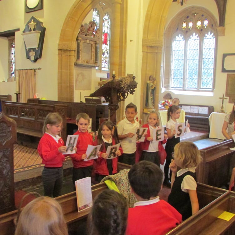 Pupils taking part in Langford Budville School's Harvest Festival service.