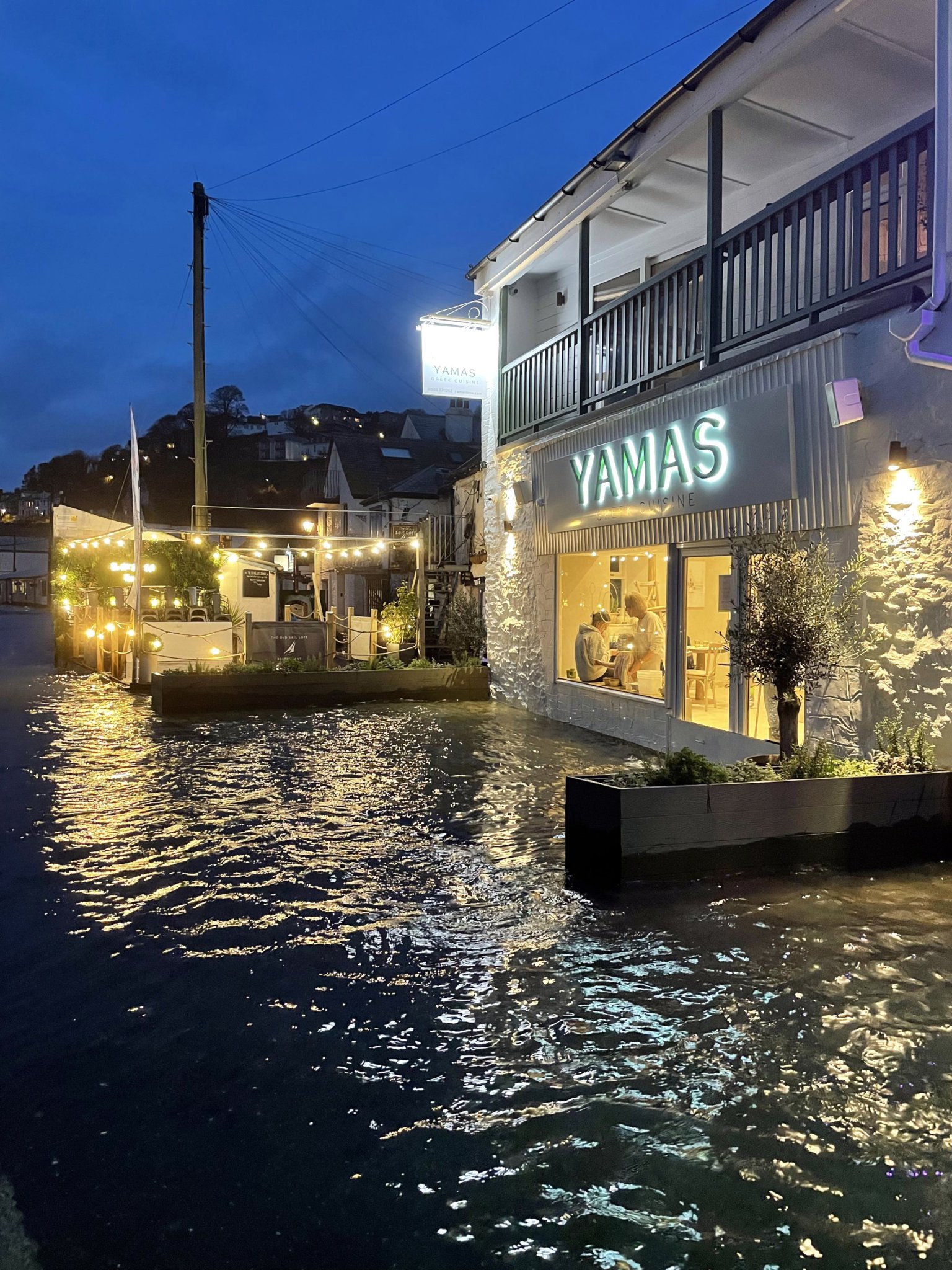 Flooding outside of Yamas in Looe. Picture: Matt Bear Clark