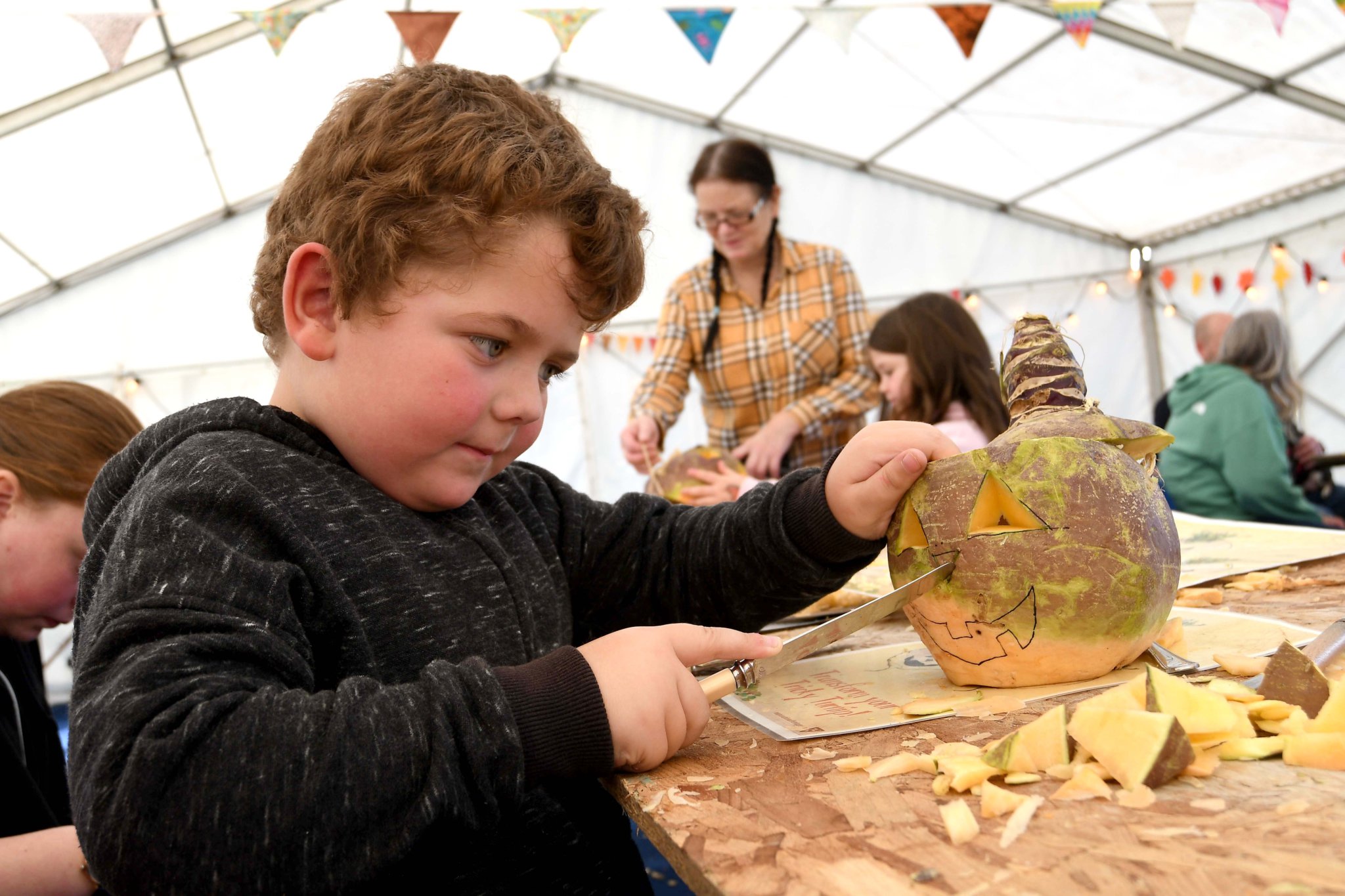 Arlo Jepson, aged 5, carves his moot at ‘Turn up for Turnips’ at Cregneash