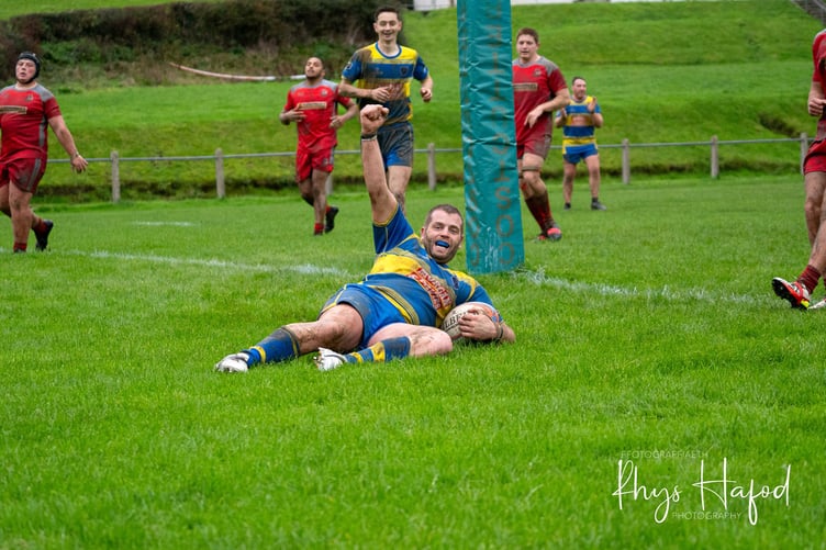 Gethin Dafis celebrates after powering over for the try