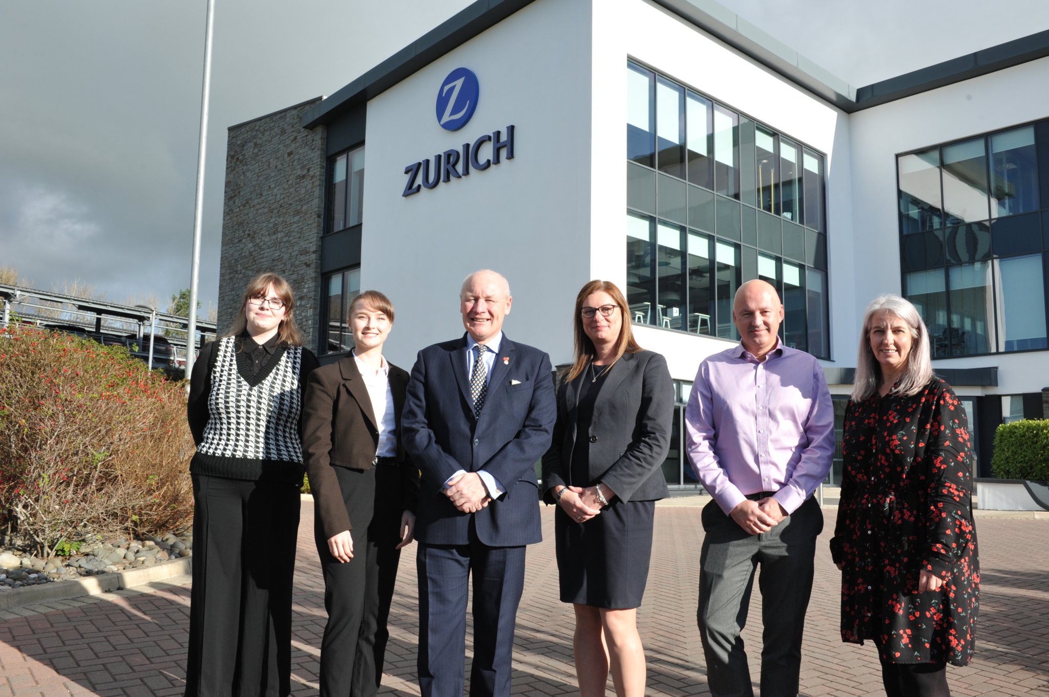 Sir John Lorimer is pictured (third from left) outside Zurich house with (left to right – all from Zurich) Emma Ames, Georgia Foxton, Stephanie Hatton, Bruce Pearson, and Serena Wood