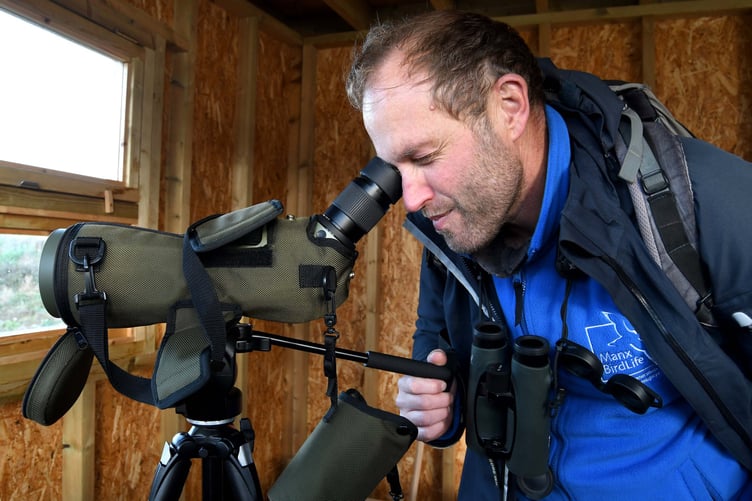 Reserve manager David Andrews scans the lake for rare ducks