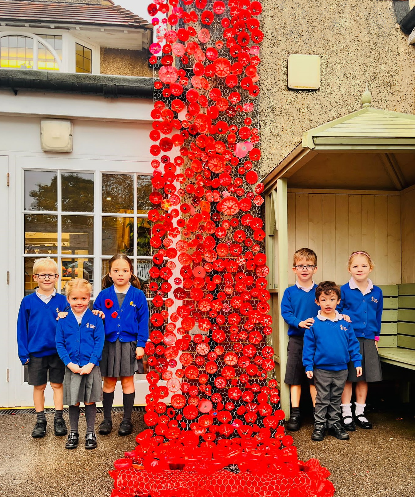 South Farnham pupils created poppies at home and then collectively formed a poignant sea of remembrance at both the infant and junior sites