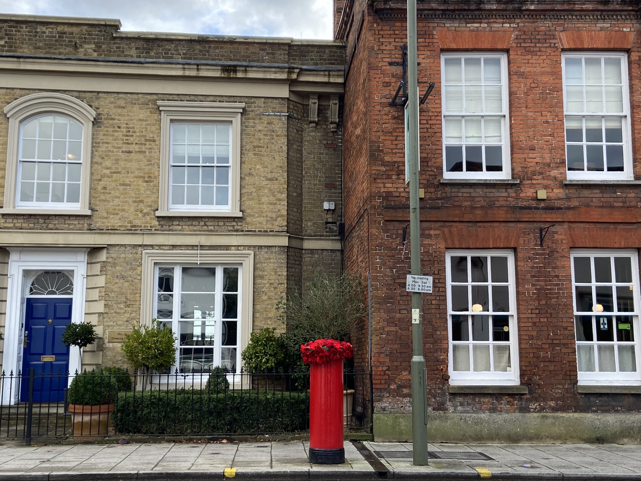 The ladies from Bourne WI collectively knitted more than 100 poppies before stitching them together for a knitted postbox topper outside the Downing Street Surgery