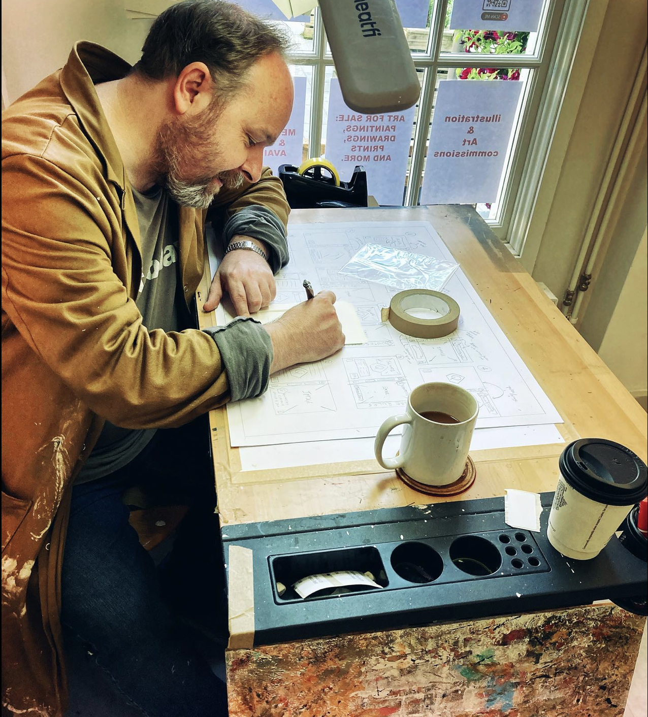 Juan Moore at work at Unit One, The Square, in Castletown’s Market Square. Three of his favourite Manx fairies are pictured, from left, Nan the cantankerous, Allen the venerable and Enda the tea drinker