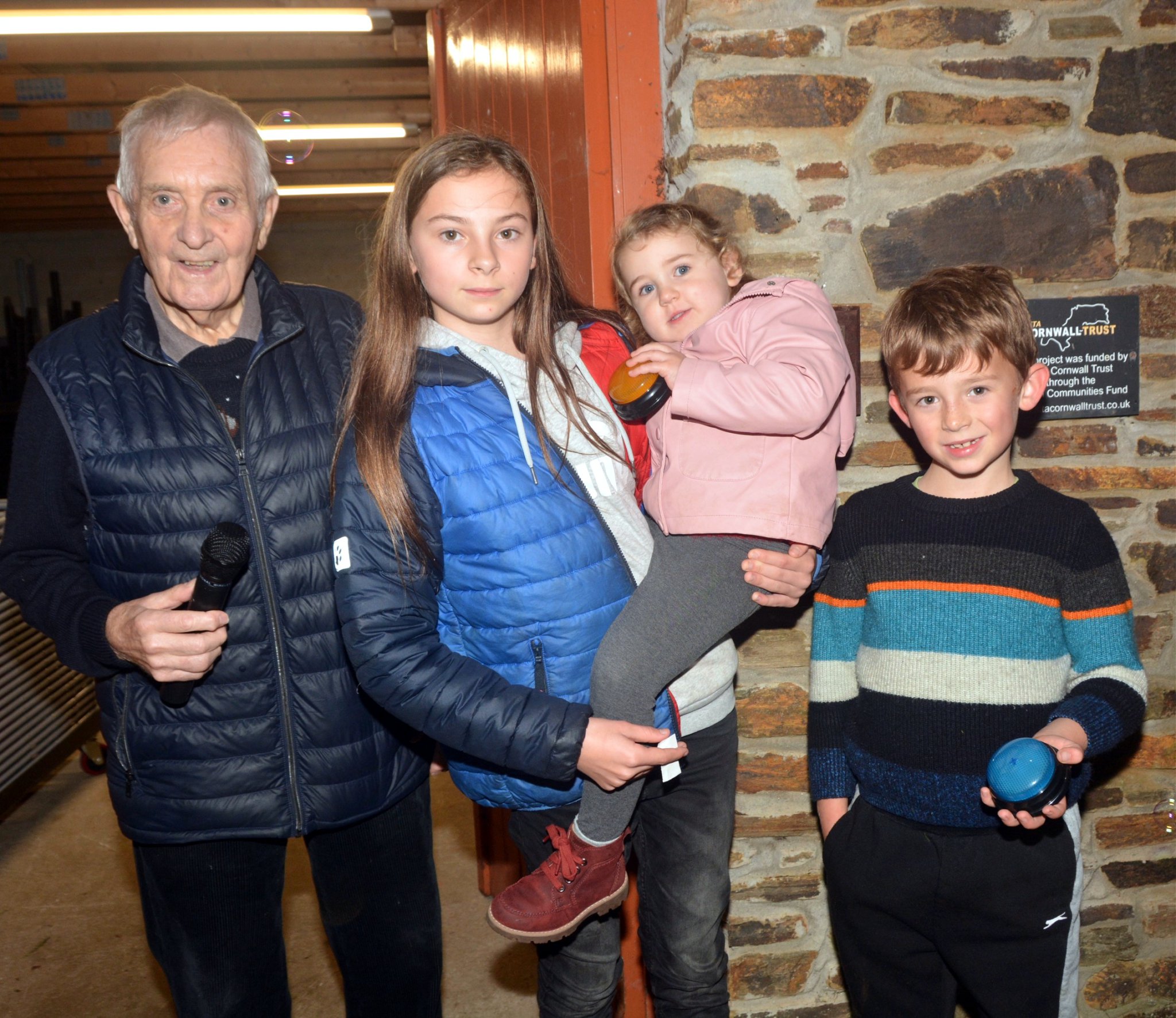 Hall chairman Mr Stephen Michael, three-year-old Esmae held by her sister Jasmine and seven-year-old Hugo, were the lucky two children who switched on the Christmas lights