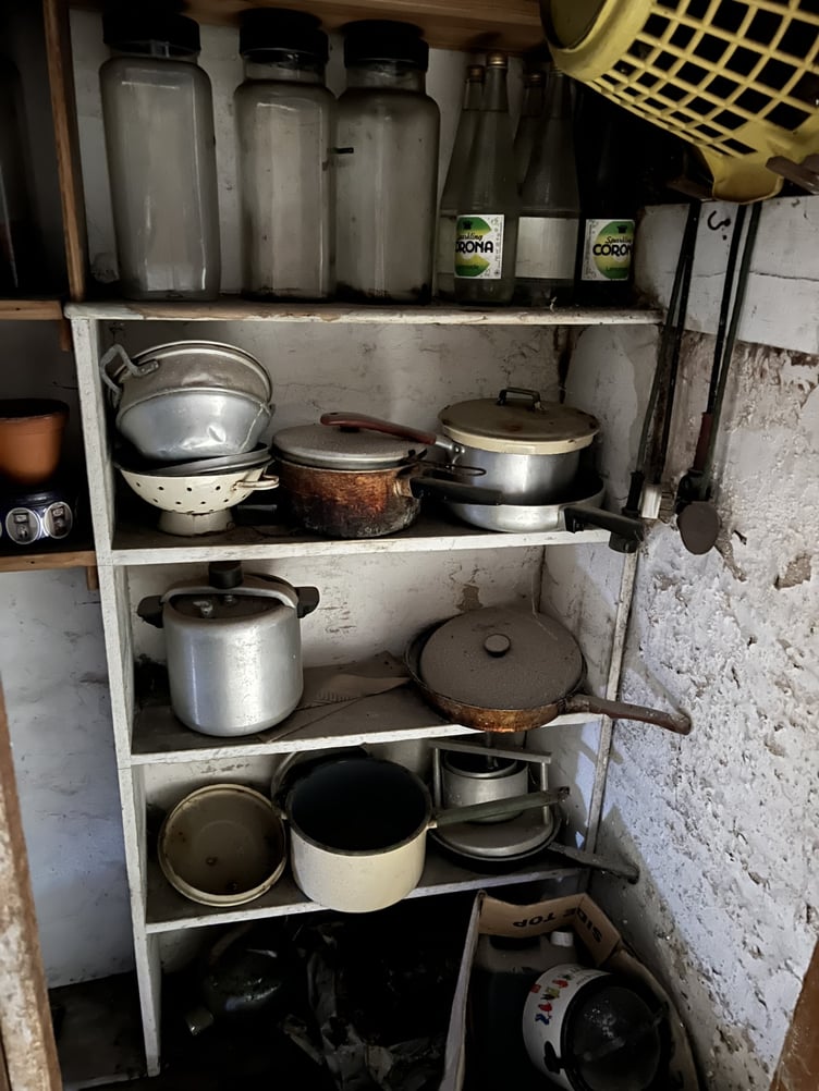 Cupboard of pots and pans inside derelict 33 Princes Street