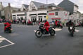 Santas travel through town in style