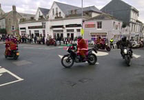 Santas travel through town in style