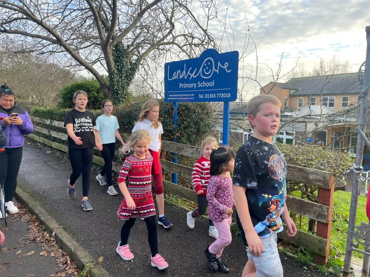 Arriving at the finish of the Landscore Primary School Santa-thon. AQ 1739