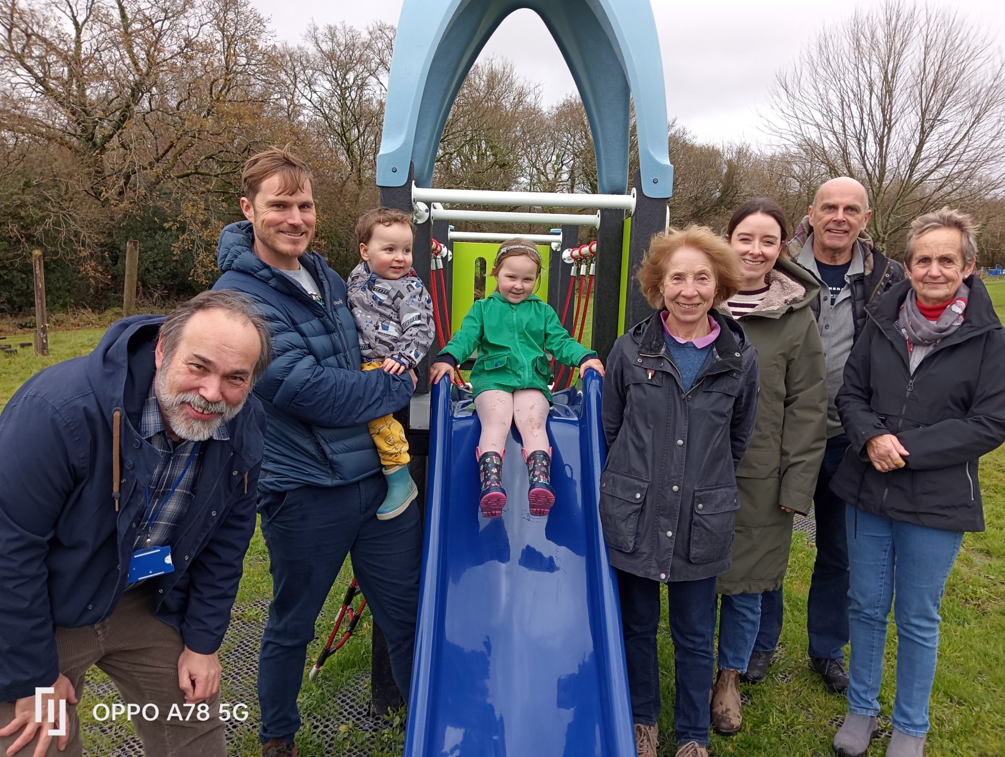 It was all smiles as the new play park was opened in Walkhampton by Cllr Chris West with a young helper pictured lower right (Picture by Jean Jameson) and joined by her parents and community leaders, pictured above.