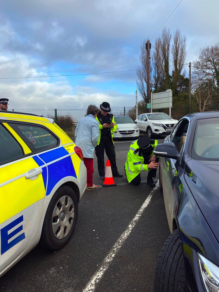 Police Officers inspecting a car for defects