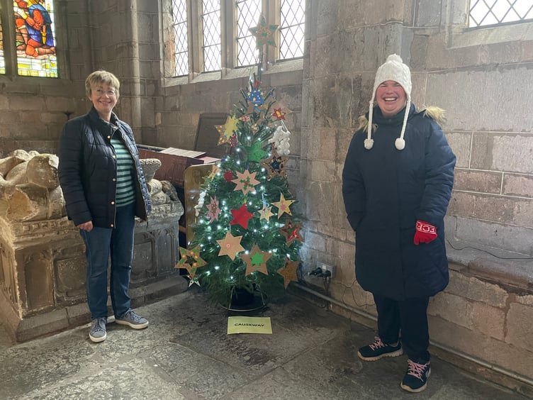 Some of those who decorated a tree for the Crediton Parish Church Christmas Tree Festival. AQ 1416