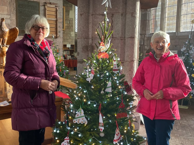 Some of those who decorated a tree for the Crediton Parish Church Christmas Tree Festival. AQ 1440